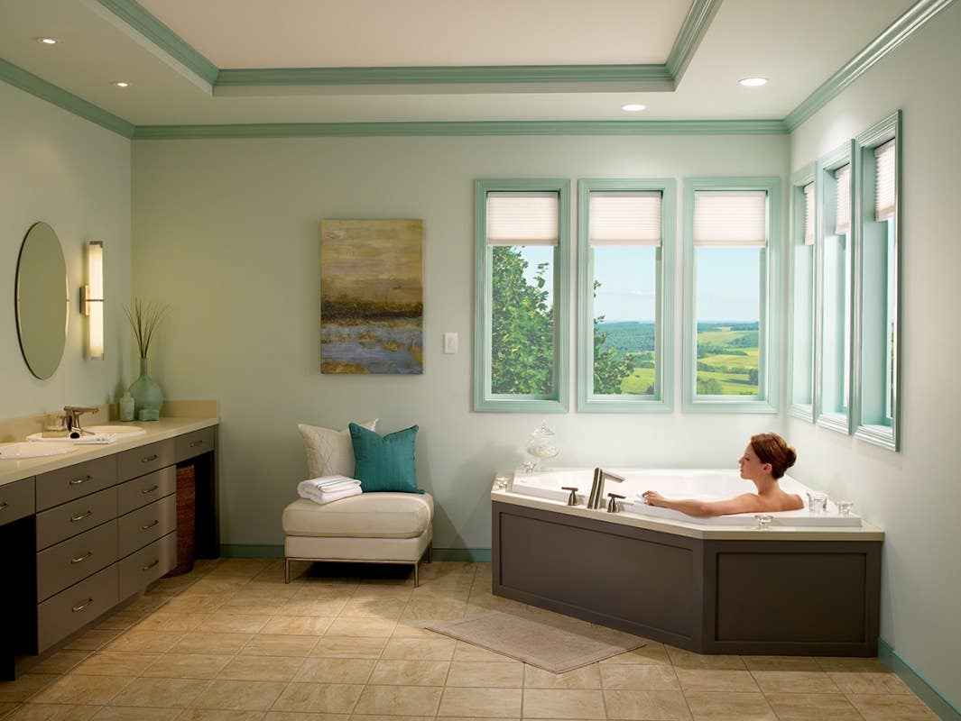 Woman in Tub with Partially Closed Light Filtering Honeycomb Shades