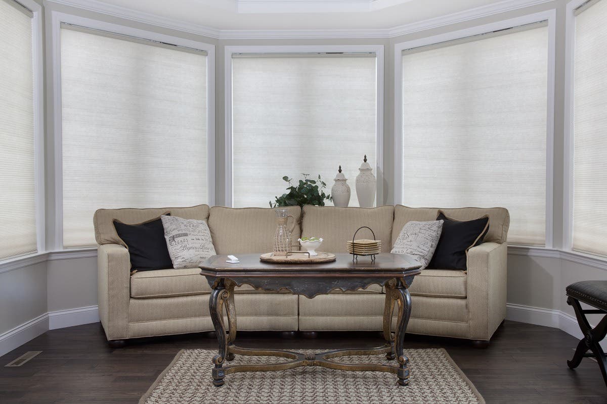 Sunroom with Empty Sofa in Front of Fully Closed Light Filtering Honeycomb Shades