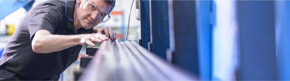 Man working with piping and wearing protective eye wear