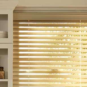 Electric wood blinds in window
