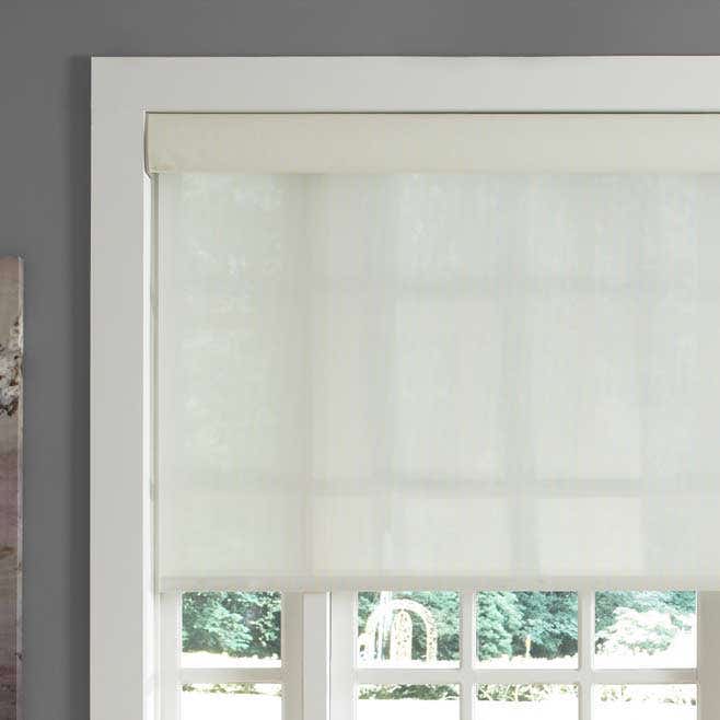 White smart roller shades pictured in window