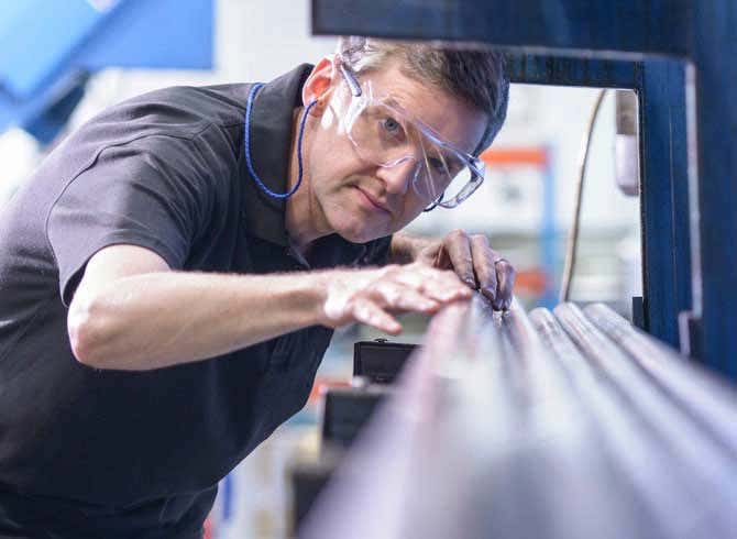 Man with protective glasses working on pipes