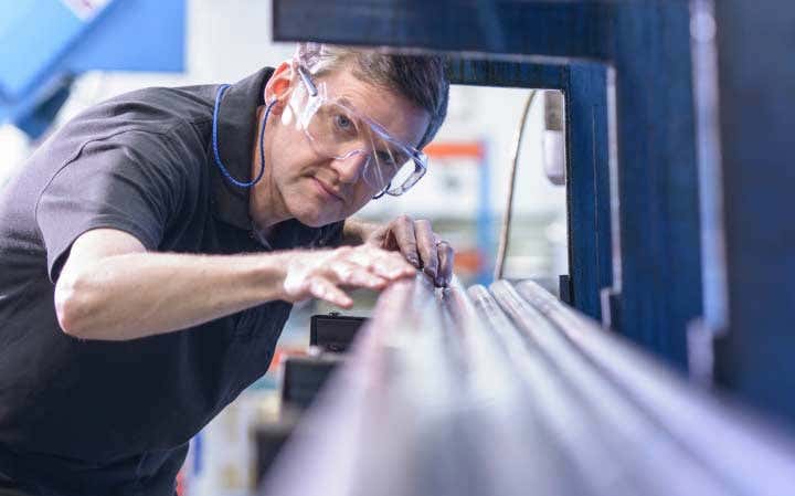 Man with protective glasses working with pipes